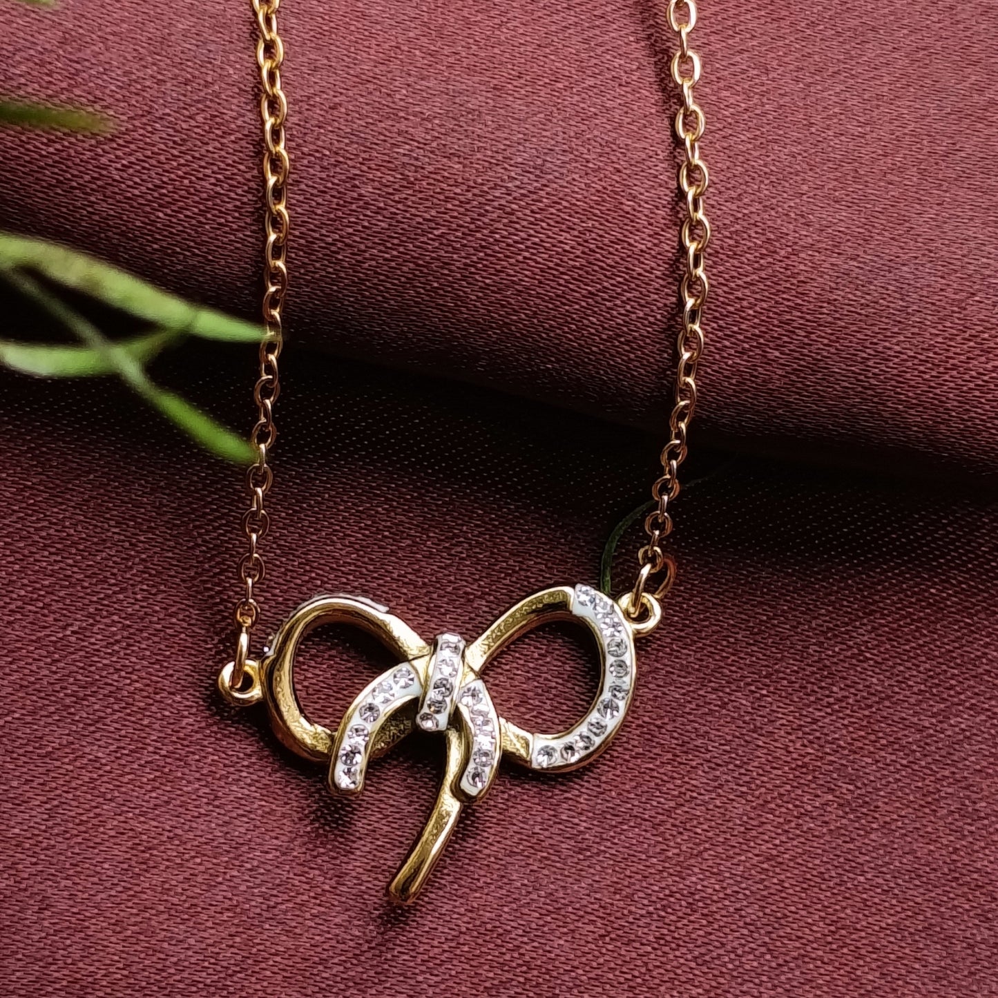 Golden Bow Pendant Necklace with Stone Accents