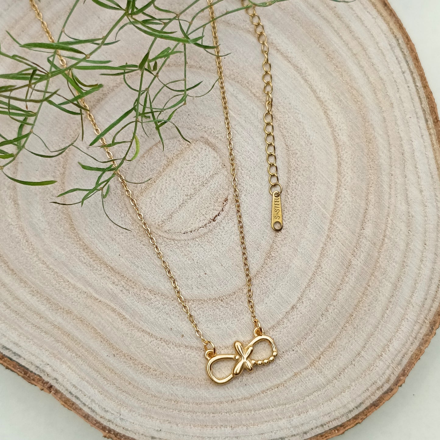 Golden Infinity Pendant Necklace with Cross Accent
